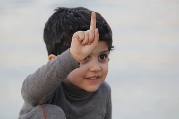 Child holding up one finger